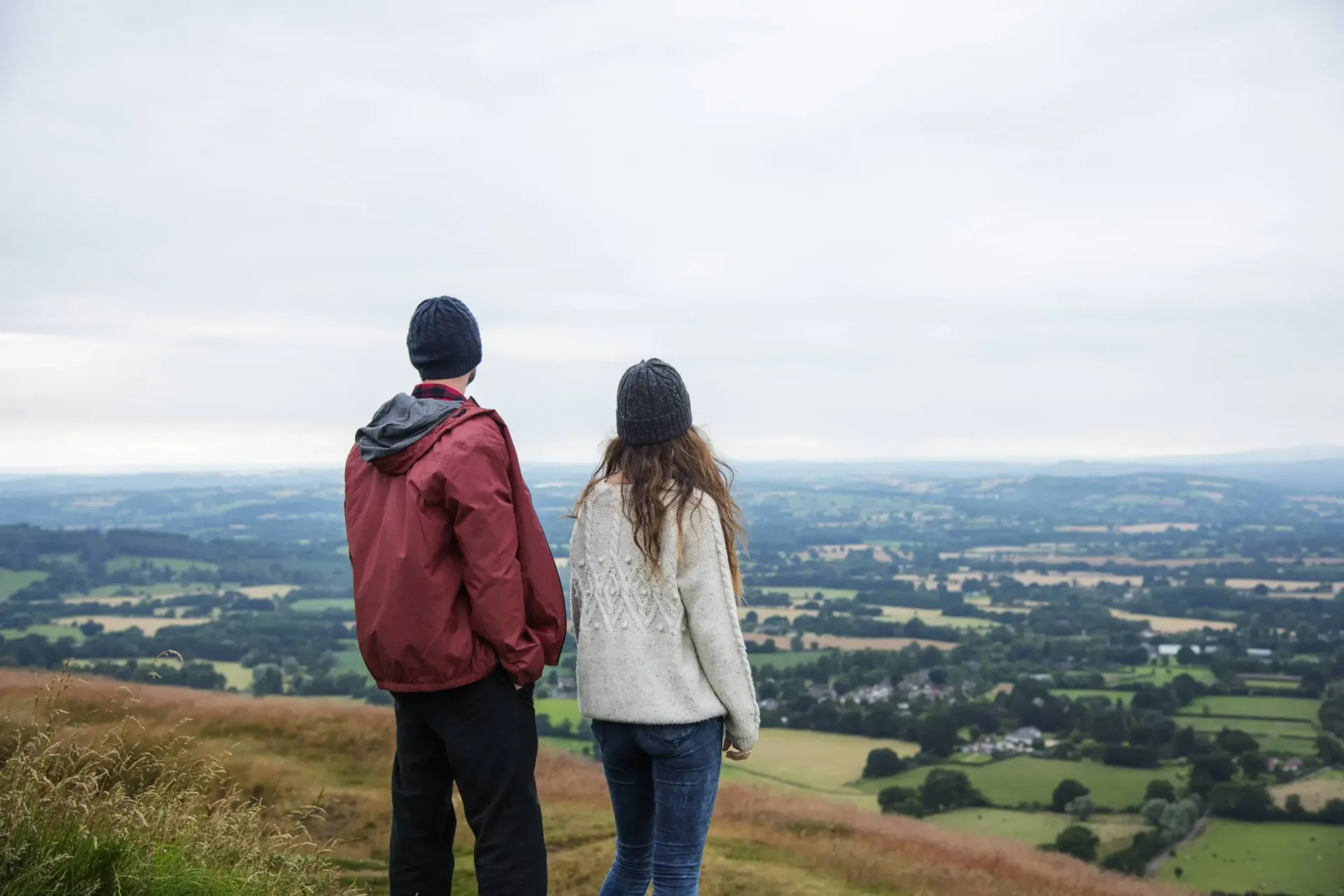 Two people looking over a wide landscape